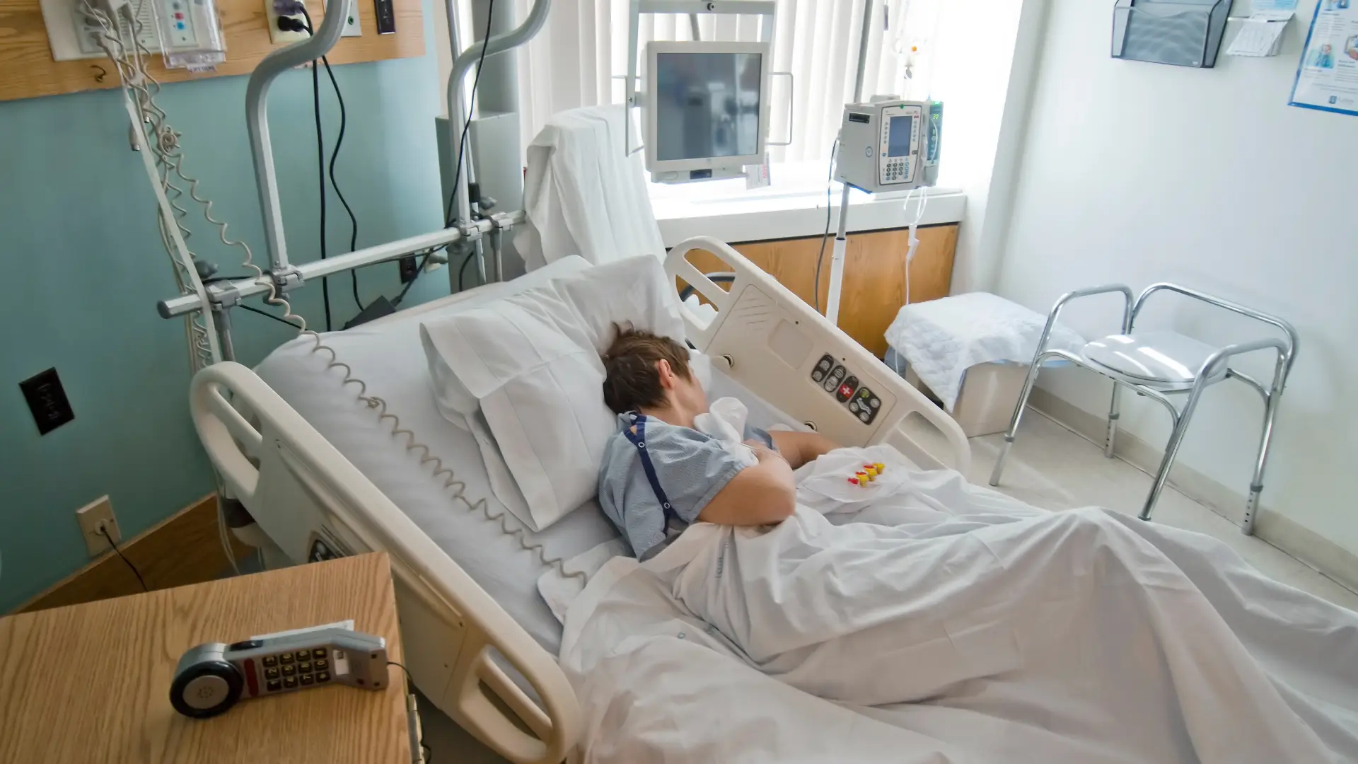 Person laying on side in hospital bed